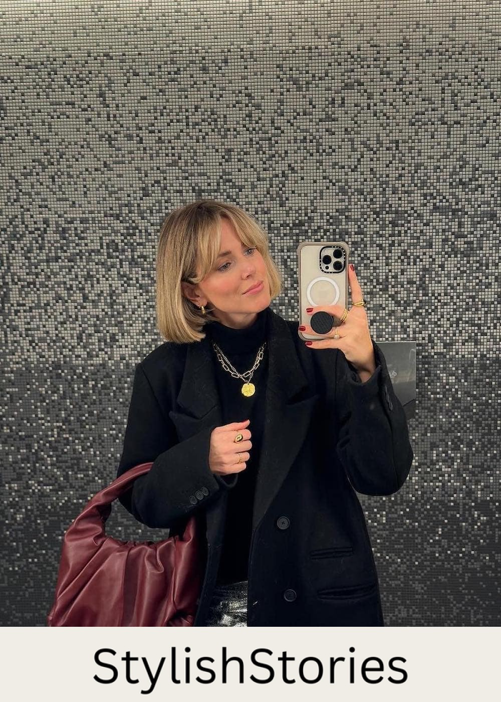 Woman wearing metallic pants with a black sweater and a black coat.