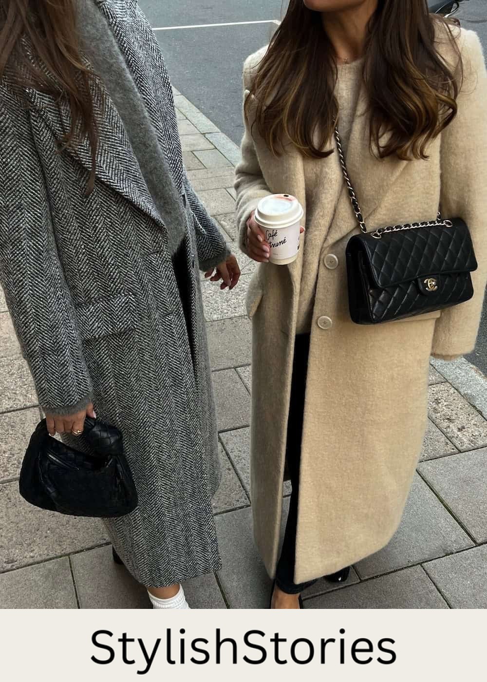 Two women wearing long wool coats in the city.