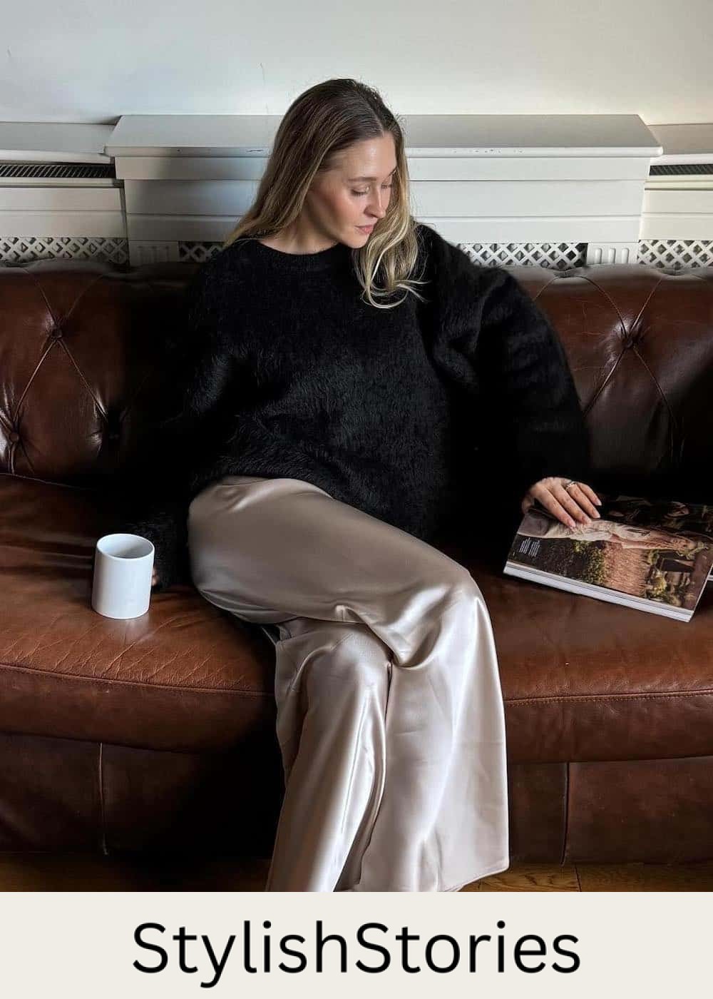 Woman wearing satin pants with a black eyelash sweater and may jane flats.