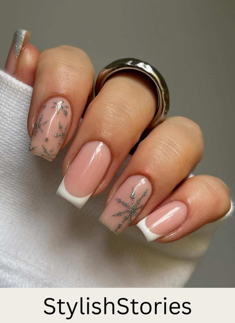 short nude nails with silver snowflake art and white tips