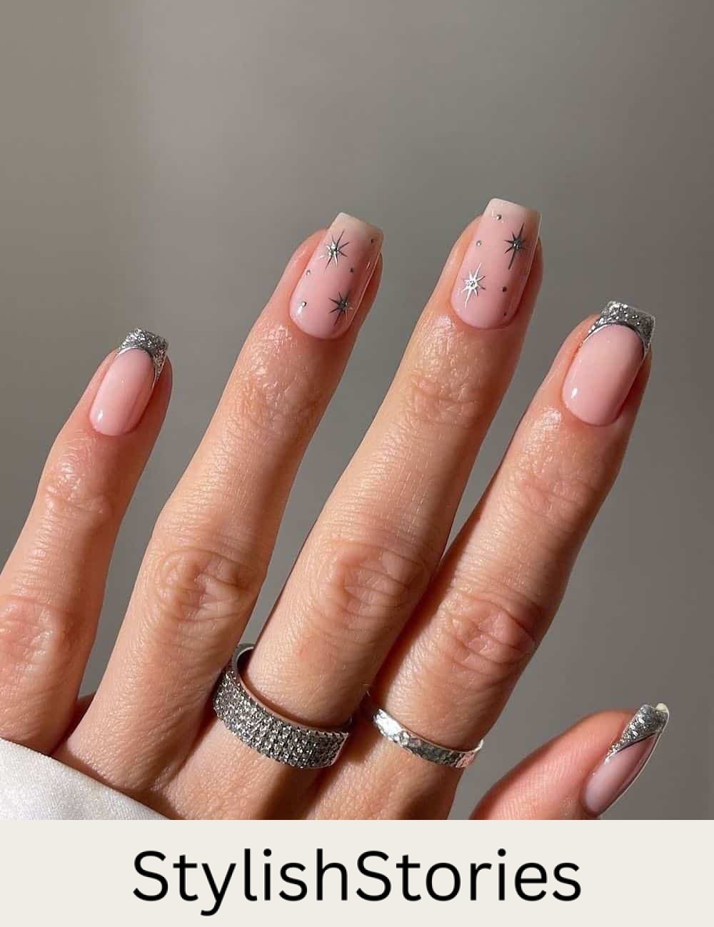 short nude nails with silver tips and sparkles