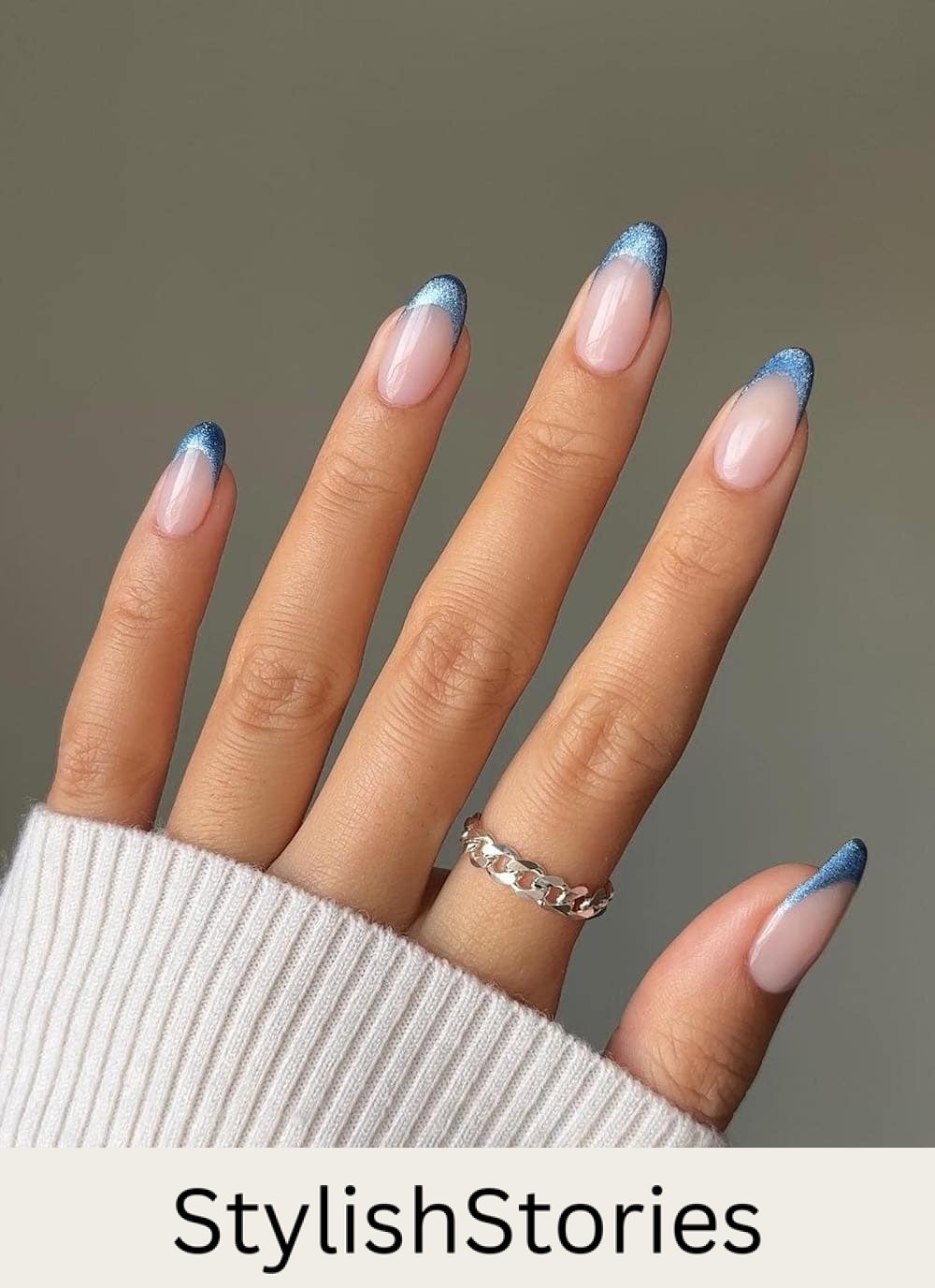long milky nude nails with shimmering blue tips