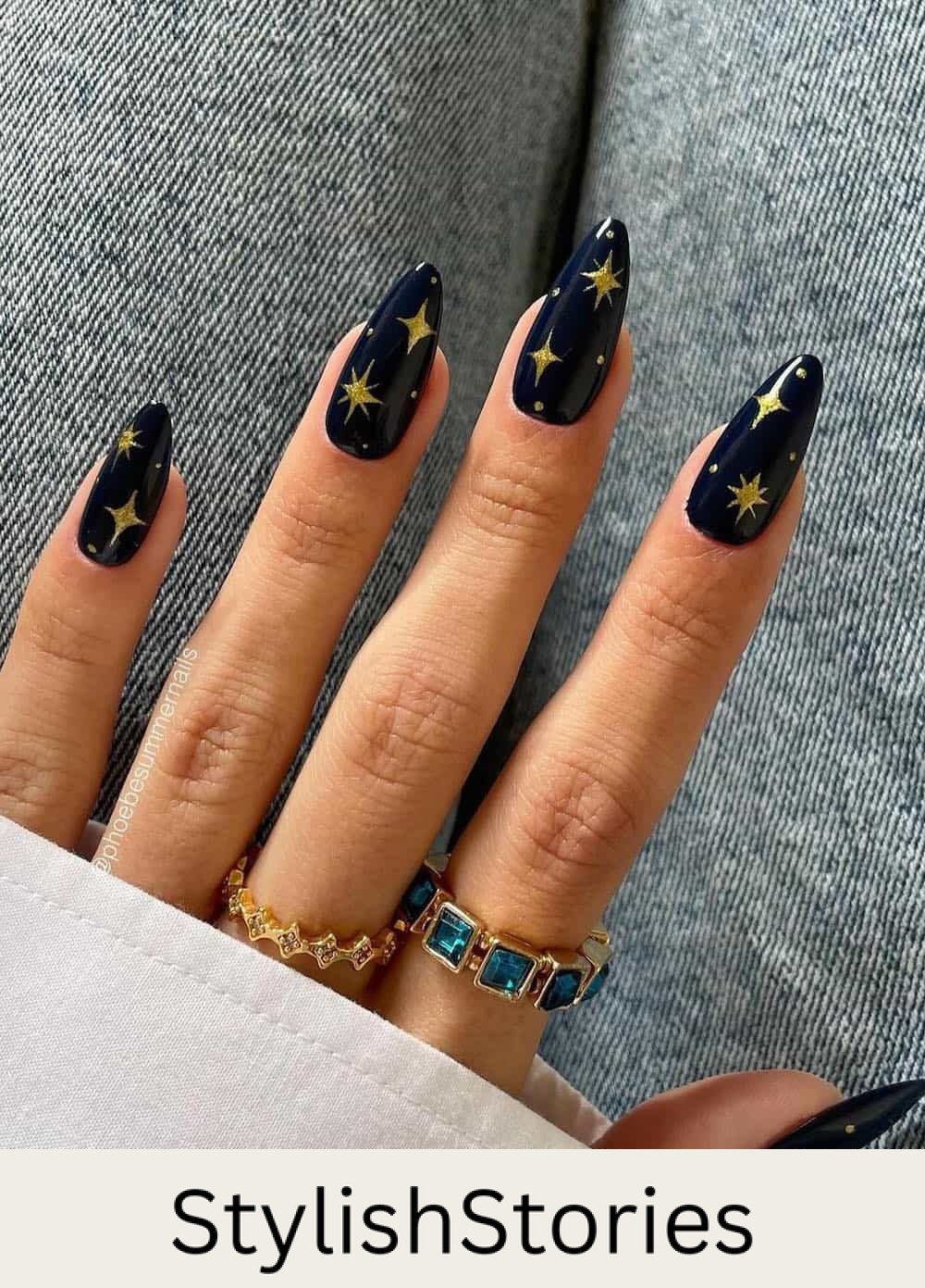 long navy almond nails with gold star and sparkle art
